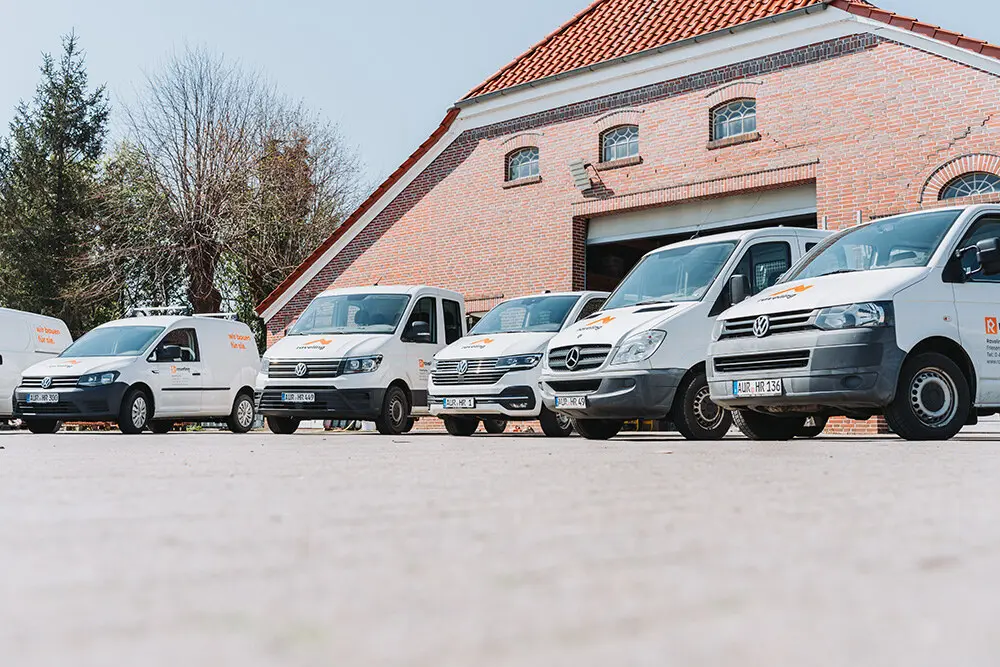 Beklebte Transporterflotte von Raveling Bau vor dem Klinker-Betriebsgebäude in Ihlow-Ochtelbur